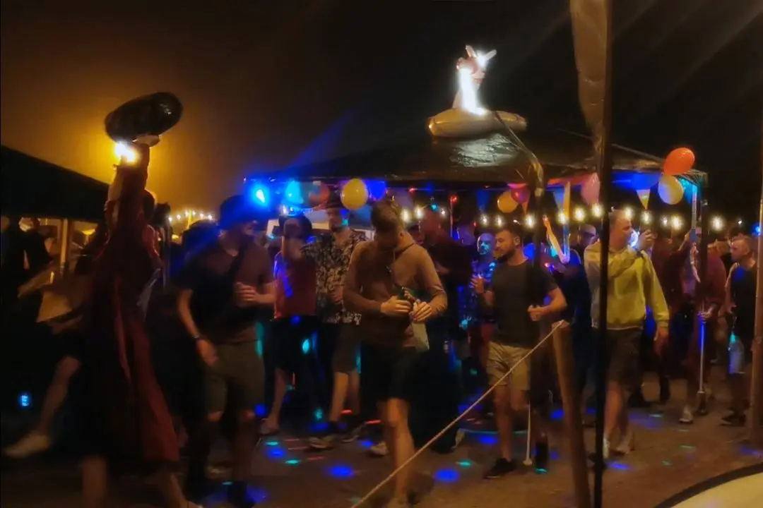 Procession of campers marching down the main aisle of camp defqon.1