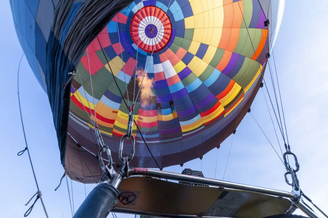 A flame comes out of the balloon's burner