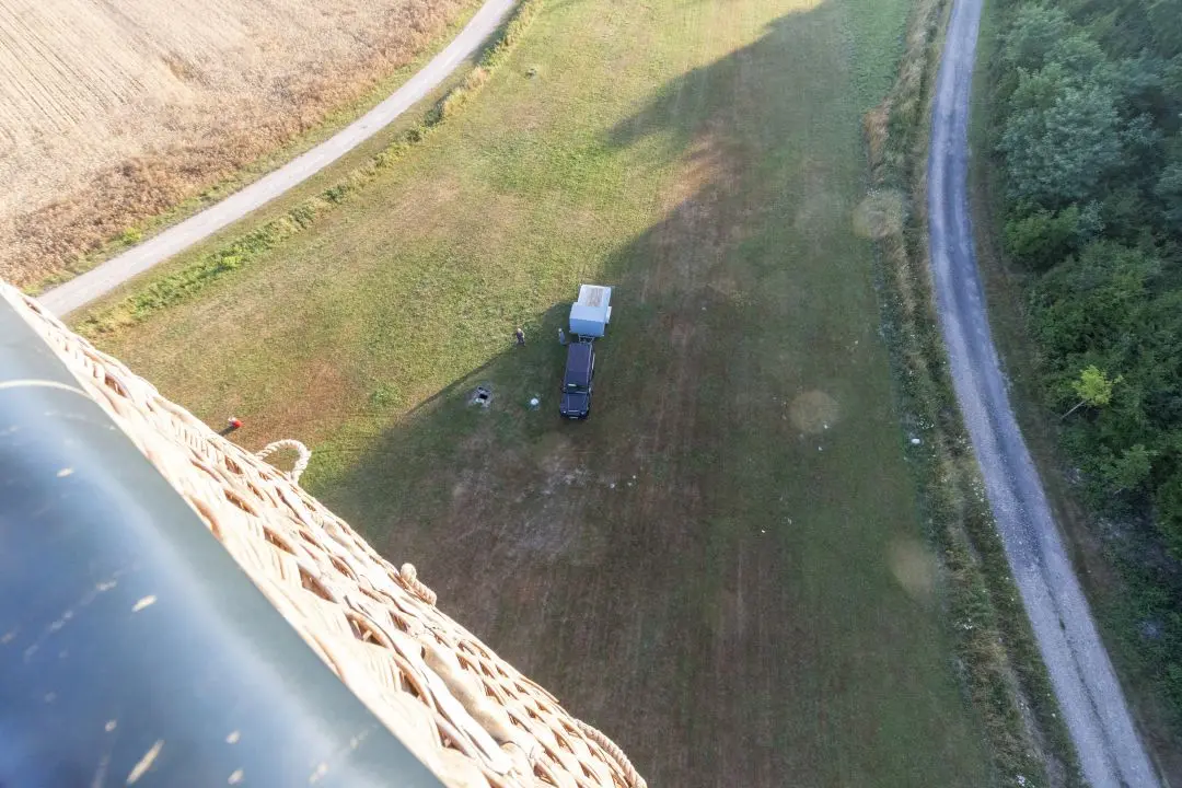 The car is small after the takeoff of the balloon