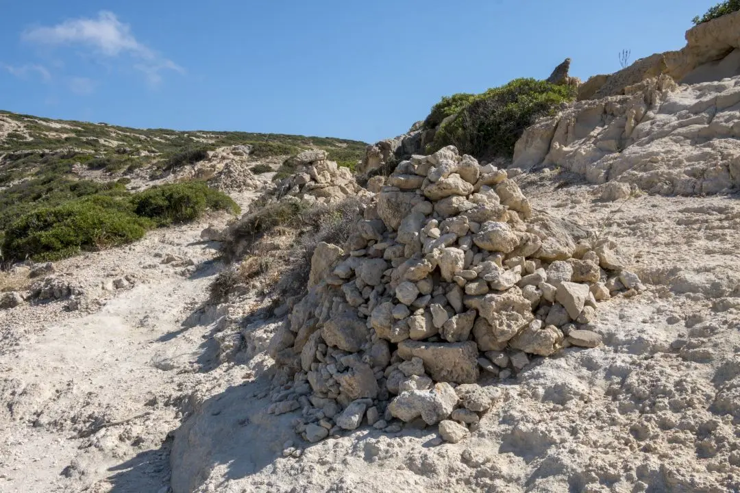 A pile of stones along the path to Red Beach