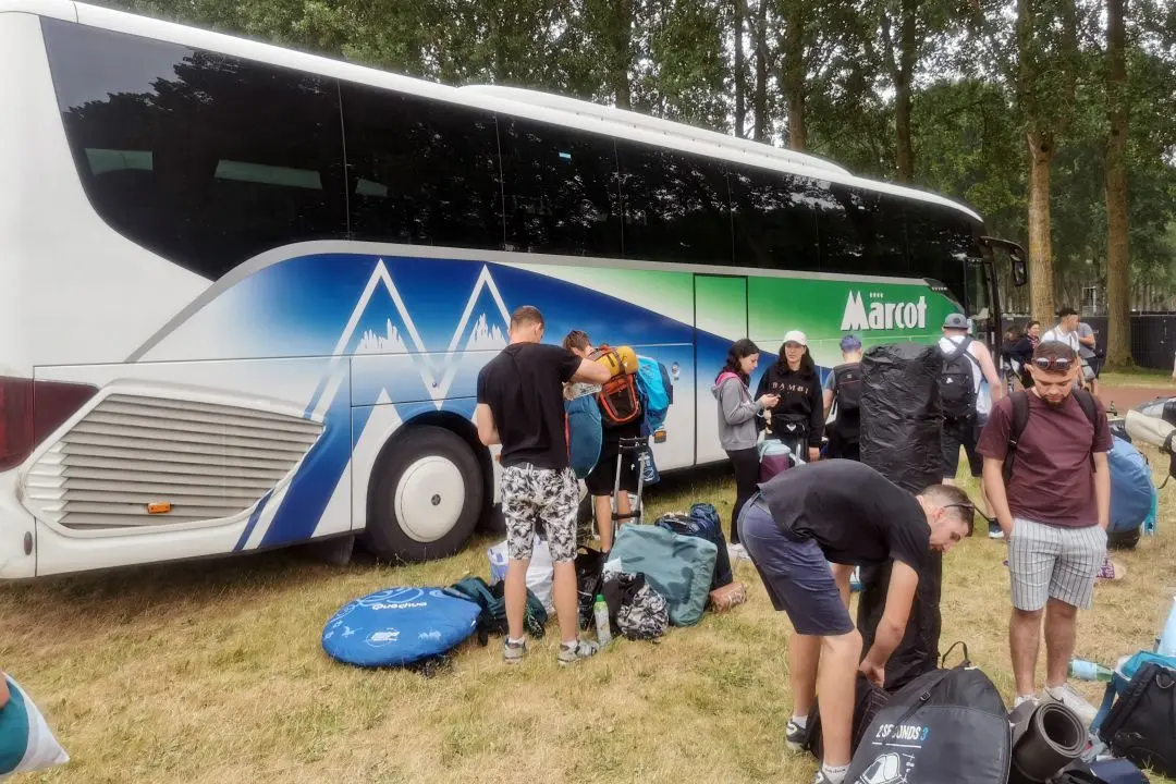 Everyone gathers their belongings when they get off the bus