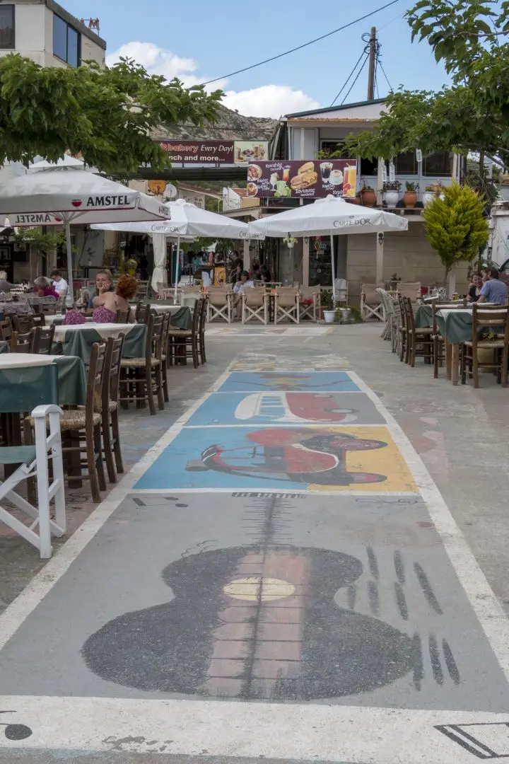 A mural on the floor of a street in Matala