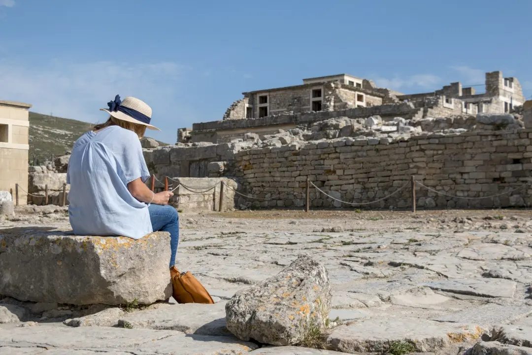 An artist drawing among the ruins